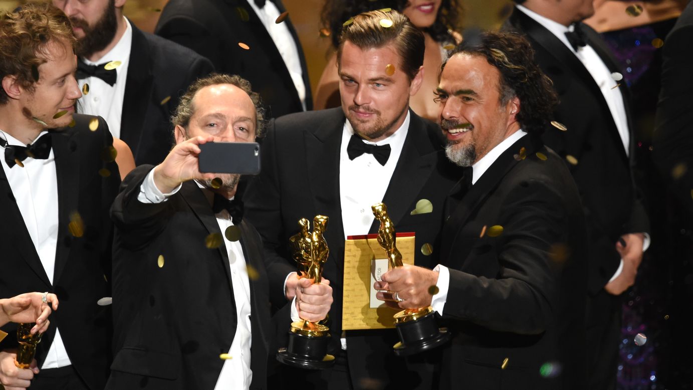 Cinematographer Emmanuel Lubezki takes an on-stage selfie with actor Leonardo DiCaprio and director Alejandro Gonzalez Inarritu during the Academy Awards on Sunday, February 28. All three won Oscars for "The Revenant."