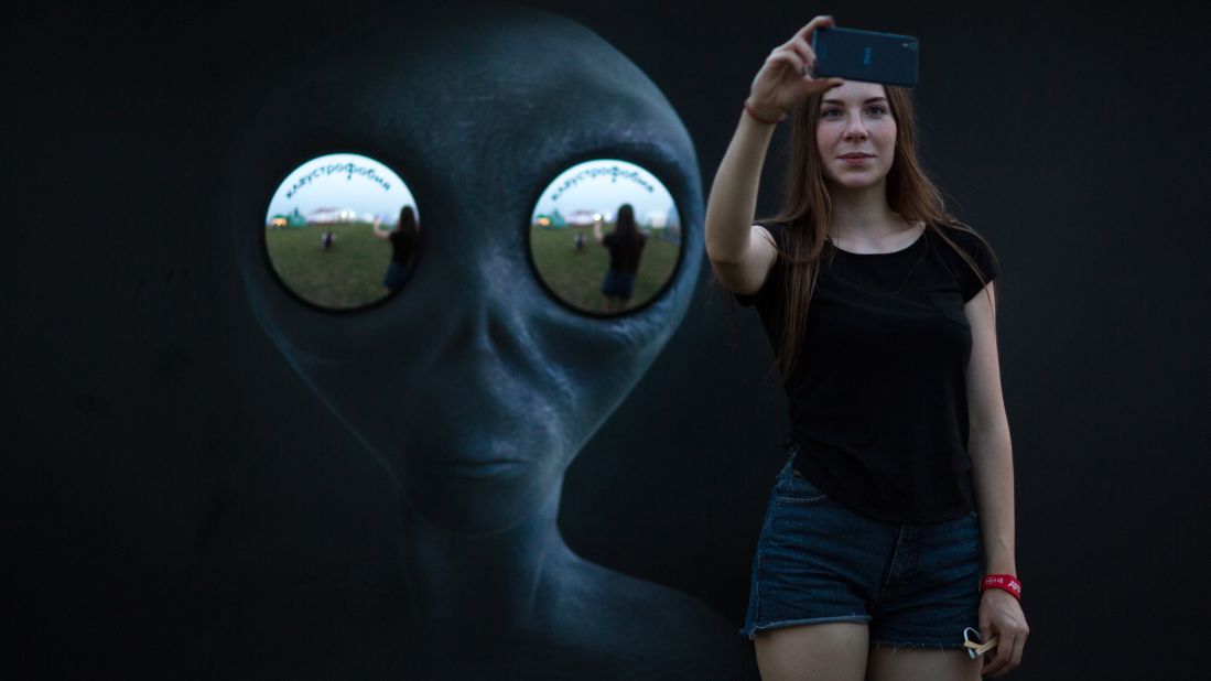 A woman takes a selfie at Alfa Future People, an electronic music festival in Nizhny Novgorod, Russia, on Friday, July 22.