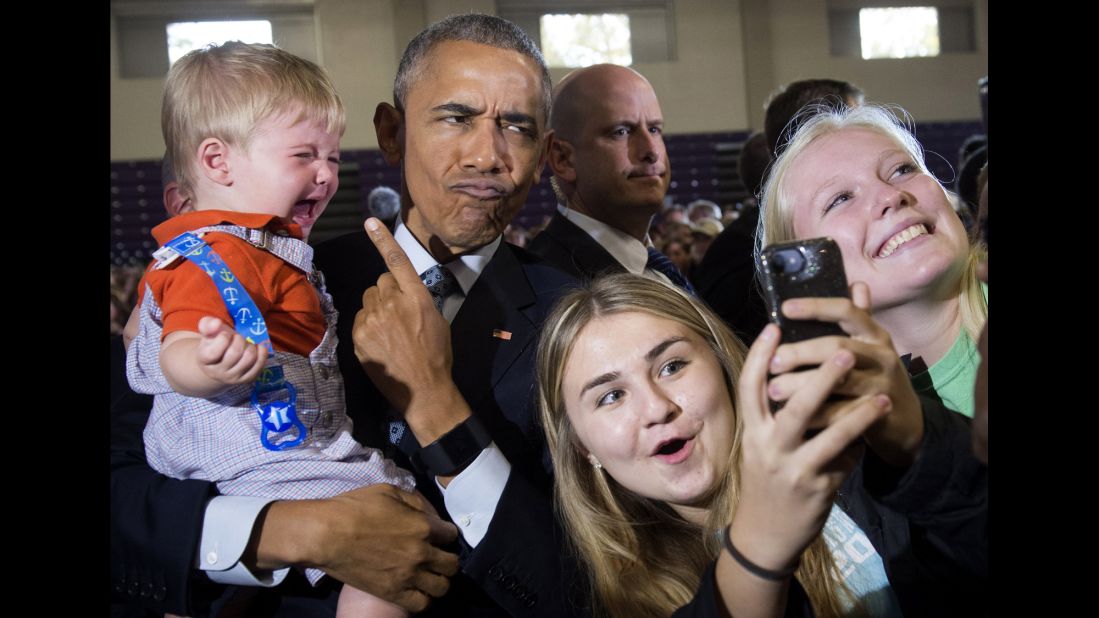 US President Barack Obama holds 10-month-old Brooks Breitwieser during a Hillary Clinton campaign event in Columbus, Ohio, on Tuesday, November 1.