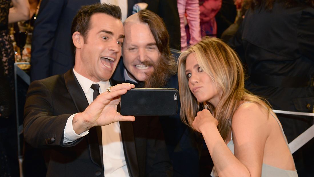 From left, actors Justin Theroux, Will Forte and Jennifer Aniston take a photo at the Critics' Choice Awards on Sunday, January 17.