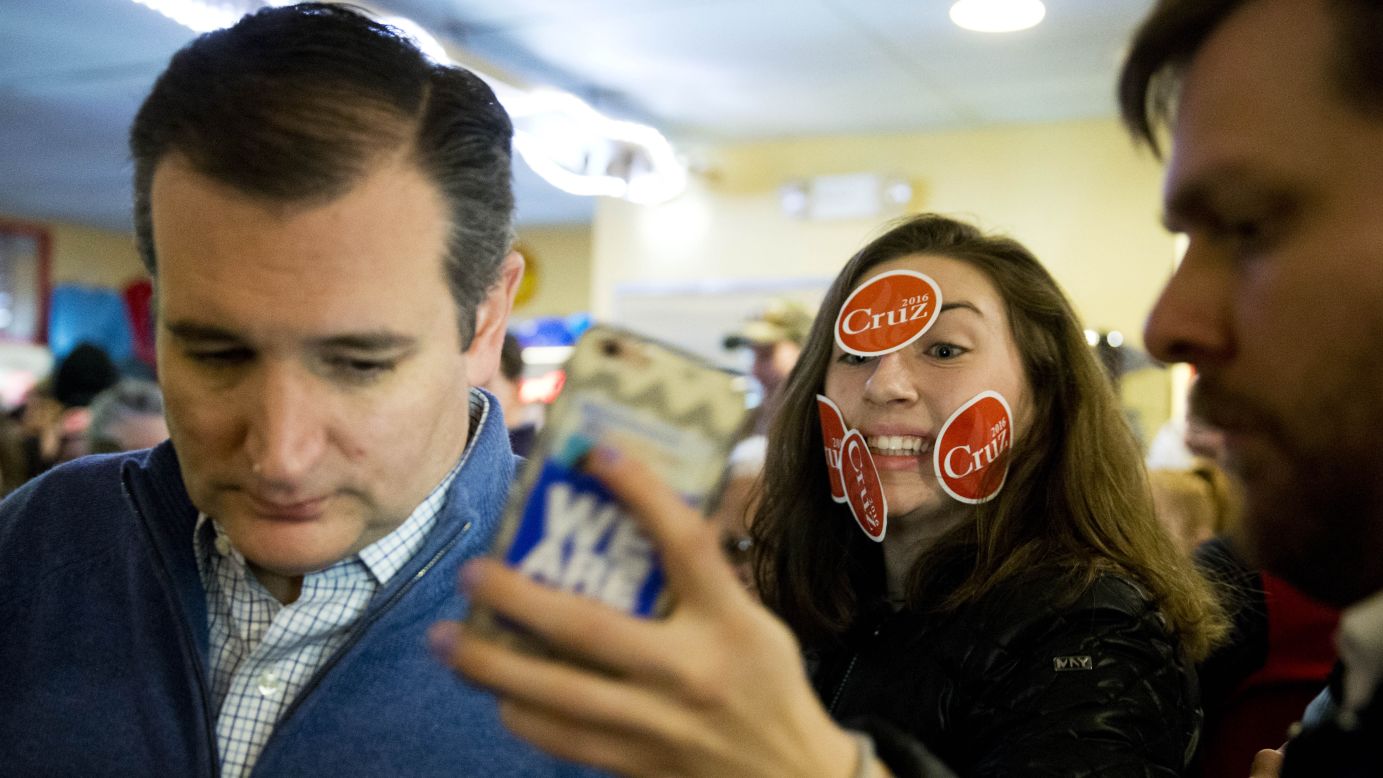A young woman tries to get a selfie with US Sen. Ted Cruz during the presidential candidate's campaign stop in Tilton, New Hampshire, on Monday, January 18.