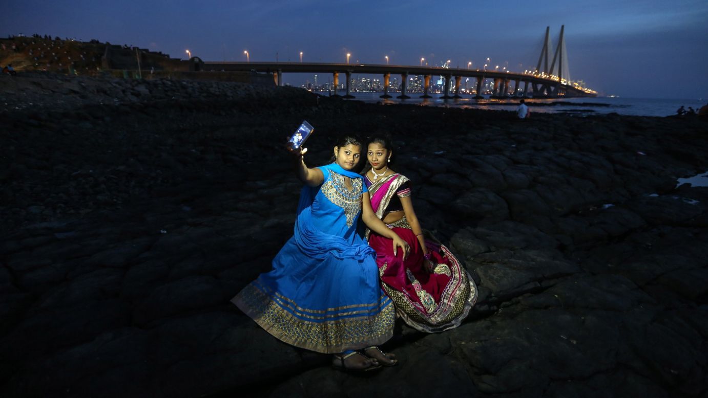 People take selfies at the Bandra Fort bandstand, a famous tourist spot in Mumbai, India, on Thursday, February 25.