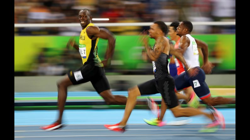 Jamaican sprinter Usain Bolt looks back at his Olympic competitors during a 100-meter semifinal on Sunday, August 14. Bolt <a href="index.php?page=&url=http%3A%2F%2Fwww.cnn.com%2F2016%2F08%2F14%2Fsport%2Fusain-bolt-justin-gatlin-olympic-games-100-meters-rio%2F" target="_blank">won the final</a> a short time later, becoming the first man in history to win the 100 meters at three straight Olympic Games.