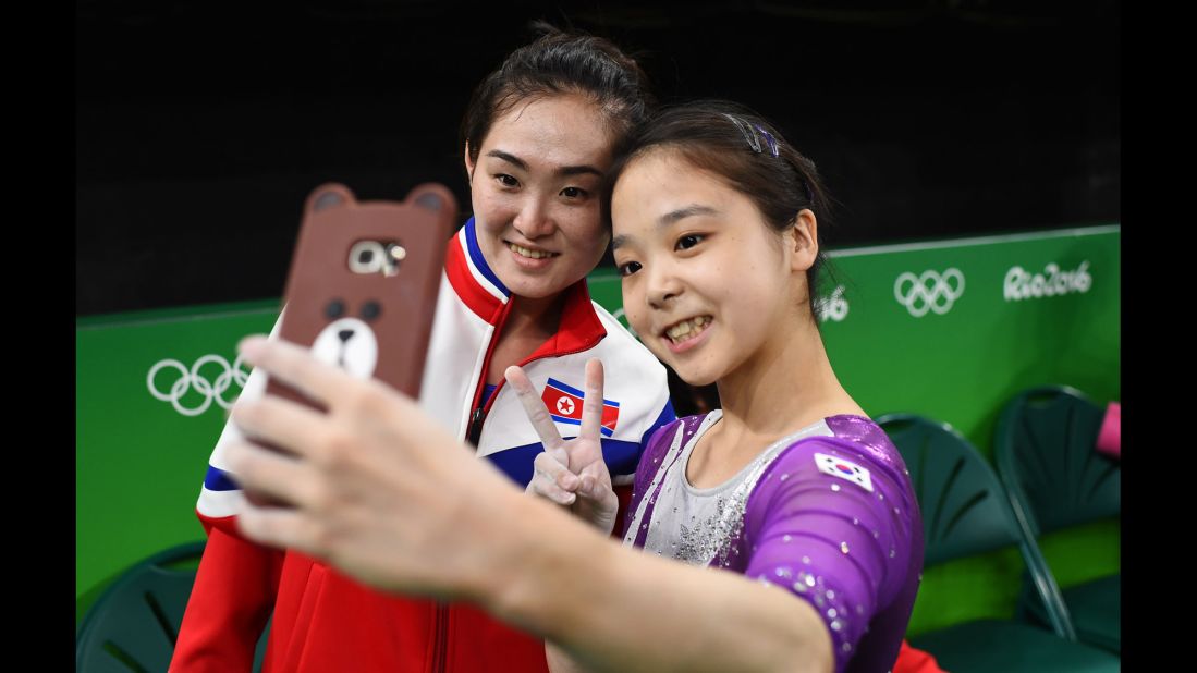 South Korean gymnast Lee Eun-ju takes a selfie with North Korean gymnast Hong Un-jong during Olympic training in Rio de Janeiro on Thursday, August 4.