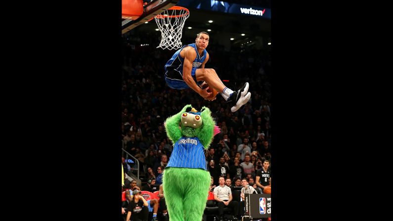 Orlando's Aaron Gordon leaps over the team's mascot, Stuff the Magic Dragon, during the <a href="index.php?page=&url=http%3A%2F%2Fwww.cnn.com%2F2016%2F02%2F08%2Fsport%2Fgallery%2Fnba-all-star-slam-dunk-champs%2Findex.html" target="_blank">NBA Slam Dunk Contest</a> on Saturday, February 13. Gordon scored a perfect 50 on the dunk, one of three 50s he had in the final round. But Zach LaVine had four and went on to win.
