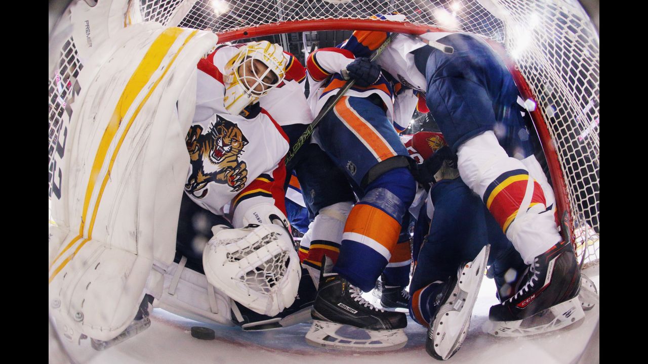 Players crowd the crease of Florida goalie Roberto Luongo during an NHL playoff game in New York on Wednesday, April 20.