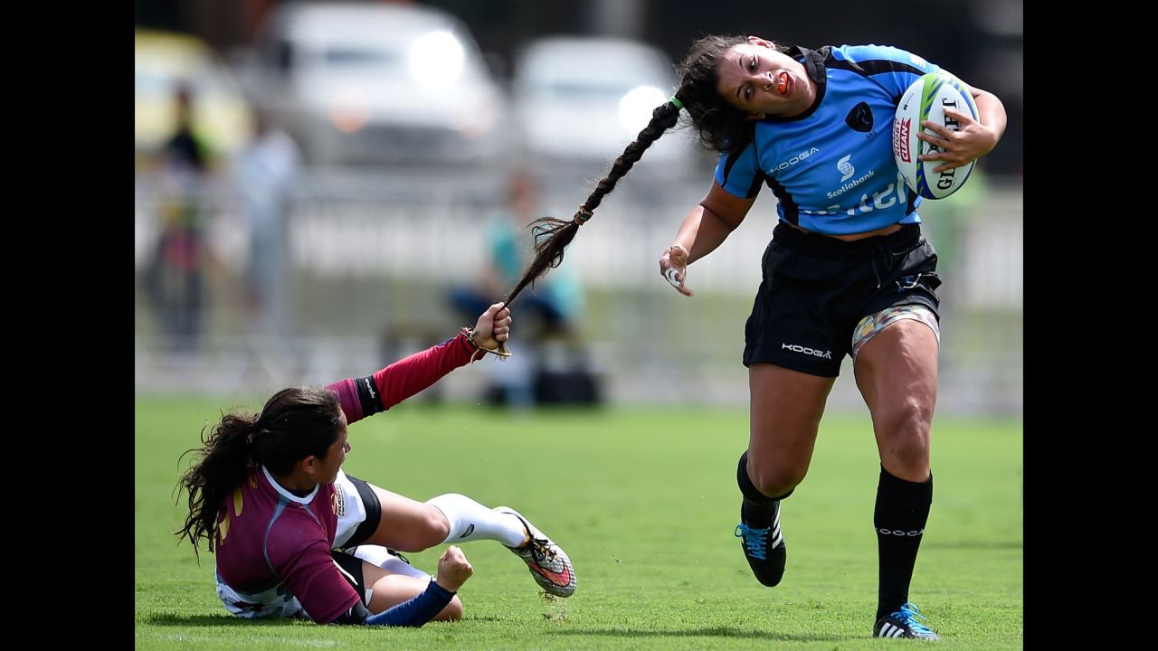 Venezuela's Maryoly Gomez pulls the hair of Uruguay's Victoria Rios during a rugby sevens match in Rio de Janeiro on Sunday, March 6.