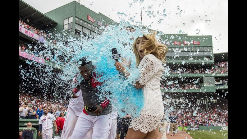 TV reporter Guerin Austin is an unlucky bystander as David Ortiz is doused by his Boston teammates on Saturday, May 14. Ortiz had just won a game with a base hit. Austin <a href="index.php?page=&url=https%3A%2F%2Ftwitter.com%2Fguerinaustin%2Fstatus%2F731925964687572992" target="_blank" target="_blank">was good-natured about the incident on Twitter</a> and wore a light-blue raincoat the next day.