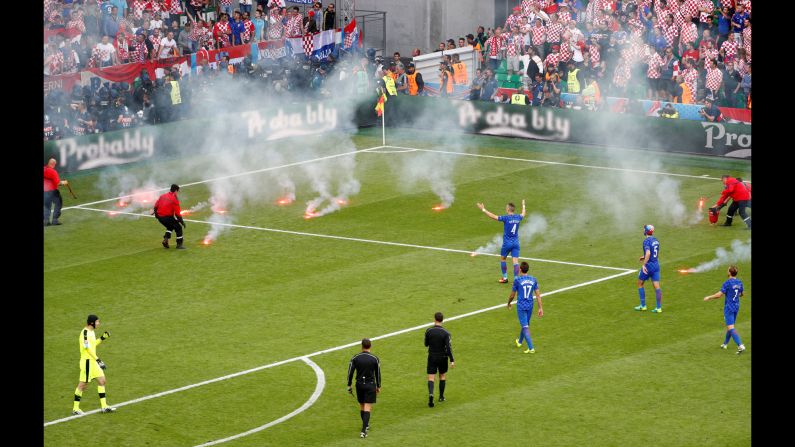 Flares, thrown onto the field from the stands, <a href="index.php?page=&url=http%3A%2F%2Fwww.cnn.com%2F2016%2F06%2F17%2Ffootball%2Fgallery%2Feuro-2016-day-8%2Findex.html" target="_blank">interrupt the Euro 2016 match</a> between Croatia and the Czech Republic on Friday, June 17. 