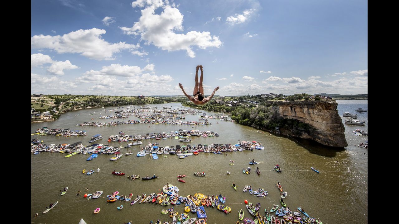 Jonathan Paredes dives into Texas' Possum Kingdom Lake on Saturday, June 4. Paredes finished first in what was the opening event of the Red Bull Cliff Diving World Series.