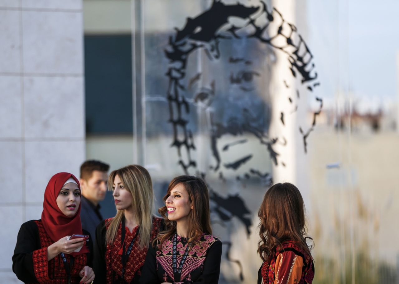 Visitors are pictured standing outside the tomb of Yasser Arafat, located next to the museum paying tribute to the former Palestinian leader.