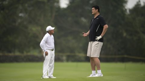 Golf legend Gary Player, left, and basketball Hall of Famer Yao Ming talk during a celebrity pro-am in Haikou, China, on Sunday, October 23. Yao is 7 feet, 6 inches -- a full 2 feet taller than Player.