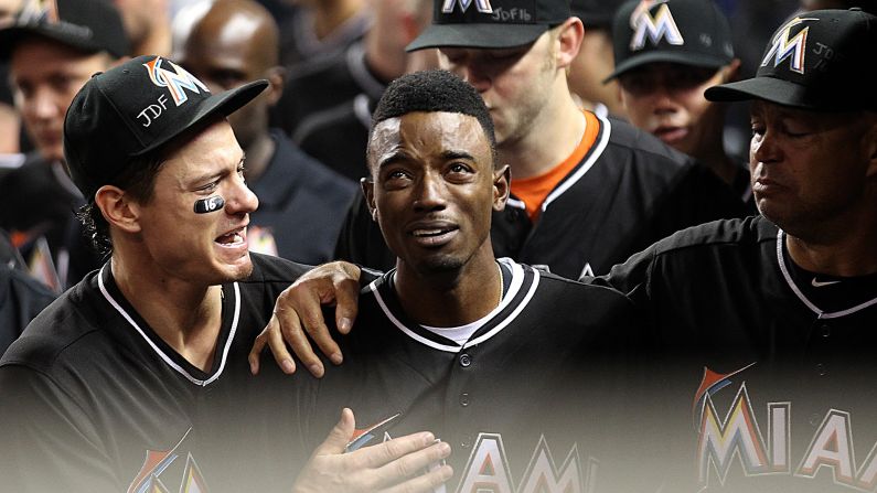 Miami Marlins second baseman Dee Gordon is consoled by teammates after hitting a leadoff home run against the New York Mets on Monday, September 26. Gordon and the rest of the Marlins were mourning teammate Jose Fernandez, <a href="index.php?page=&url=http%3A%2F%2Fwww.cnn.com%2F2016%2F09%2F25%2Fus%2Fmlb-pitcher-jose-fernandez-dead%2F" target="_blank">who died in a boating accident</a> the day before at the age of 24.