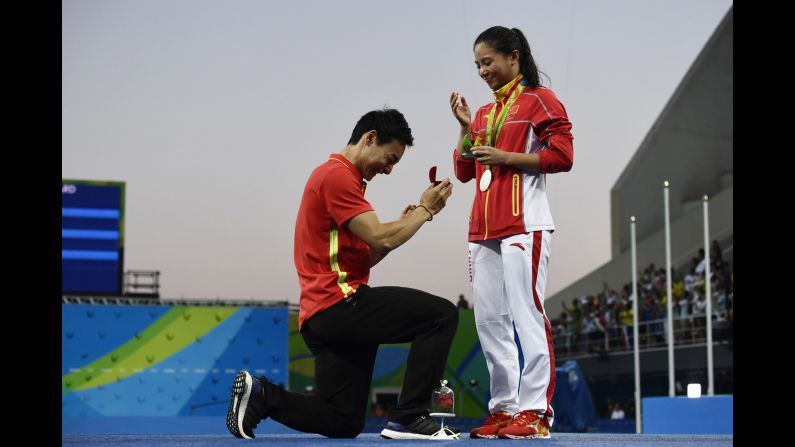 China's Qin Kai <a href="index.php?page=&url=http%3A%2F%2Fwww.cnn.com%2F2016%2F08%2F14%2Fsport%2Fchina-diving-marriage-proposal-rio-2016-olympics%2Findex.html" target="_blank">proposes to fellow diver He Zi</a> after she received Olympic silver in the 3-meter springboard on Sunday, August 14.