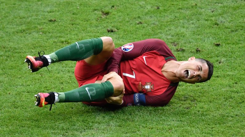 Cristiano Ronaldo reacts after a tackle by Dimitri Payet during <a href="index.php?page=&url=http%3A%2F%2Fwww.cnn.com%2F2016%2F07%2F10%2Ffootball%2Ffrance-portugal-euro-2016-final%2Findex.html" target="_blank">the Euro 2016 final</a> between Portugal and France on Sunday, July 10. Portugal won despite Ronaldo being forced to leave the game with a knee injury.