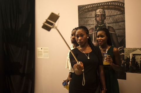 Smartphone sales now account for 23% of the mobile phone market. These sales are set to increase as infrastructure is modernized and network coverage improves. <br /><br />Pictured: Visitors take selfies during the opening of the Lagos Photo festival in Lagos on October 22, 2016.   