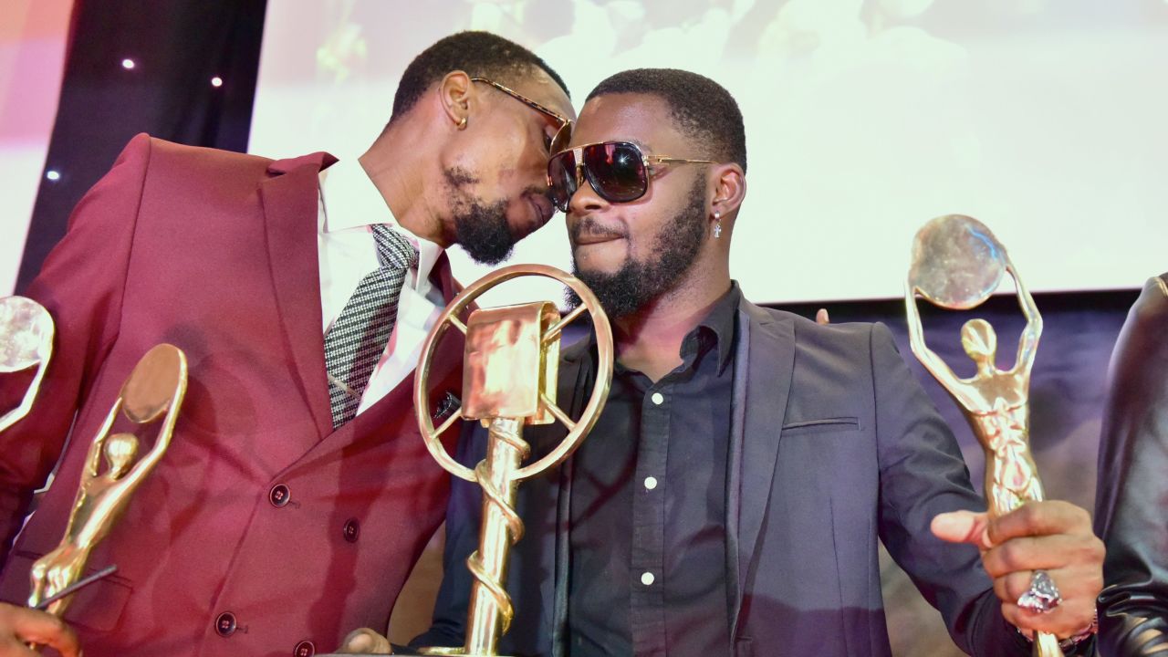 Ivory Coast's coupe-decale musician DJ Arafat (R) and DJ Serge Beynaud present their awards during the Coupe-Decale Awards on October 15, 2016 in Abidjan.