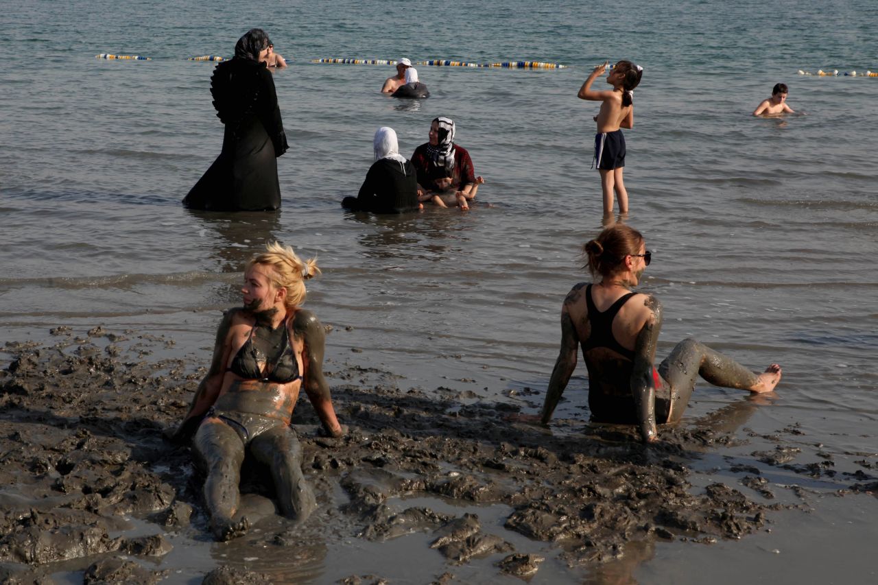 Tourists bathe in the waters of the Dead Sea in the West Bank.  