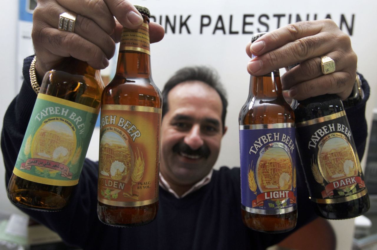 Nadim Khoury displays the products made at his brewery, named after his home village of Taybeh, in the West Bank. 