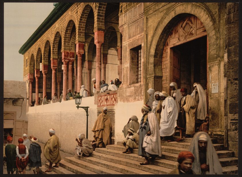 Men leaving a mosque in Tunis, Tunisia circa 1899. Captured using a photolithography method known as a photochrom, it was an early way to create color stills from a camera.