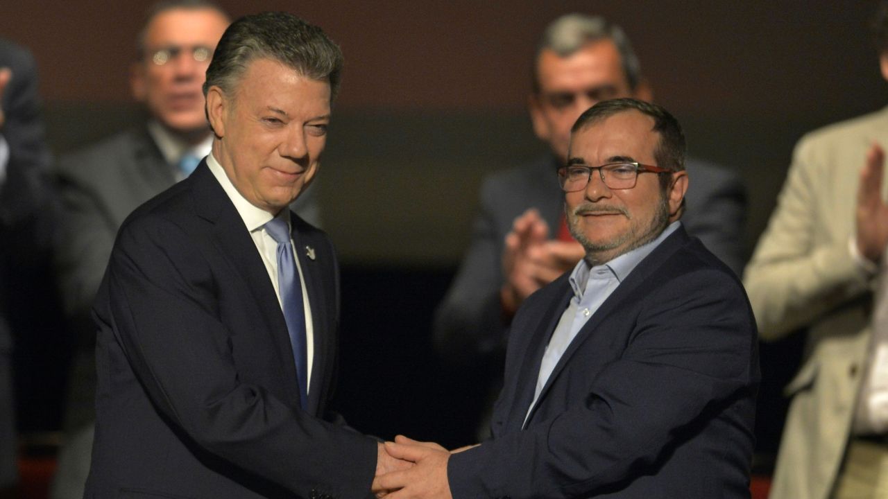 Colombian President Juan Manuel Santos and the head of the FARC, guerrilla Timoleon Jimenez, shake hands in April during the second signing of the historic peace agreement.