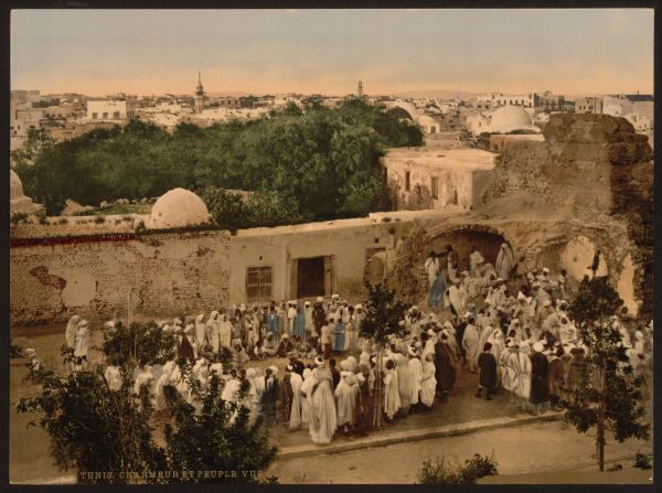 A crowd surrounds a snake charmer in Tunis. Photochroms were created by taking the negative and exposing it to multiple flat surfaces such as stone, glass or zinc. As many as 24 separate slides would we be used, each printing a different color. Together the inks would blend and create realistic hues. (Find out more about the process <a href="index.php?page=&url=http%3A%2F%2Fwww.loc.gov%2Fpictures%2Fcollection%2Fpgz%2Fprocess.html" target="_blank" target="_blank">here</a>.)