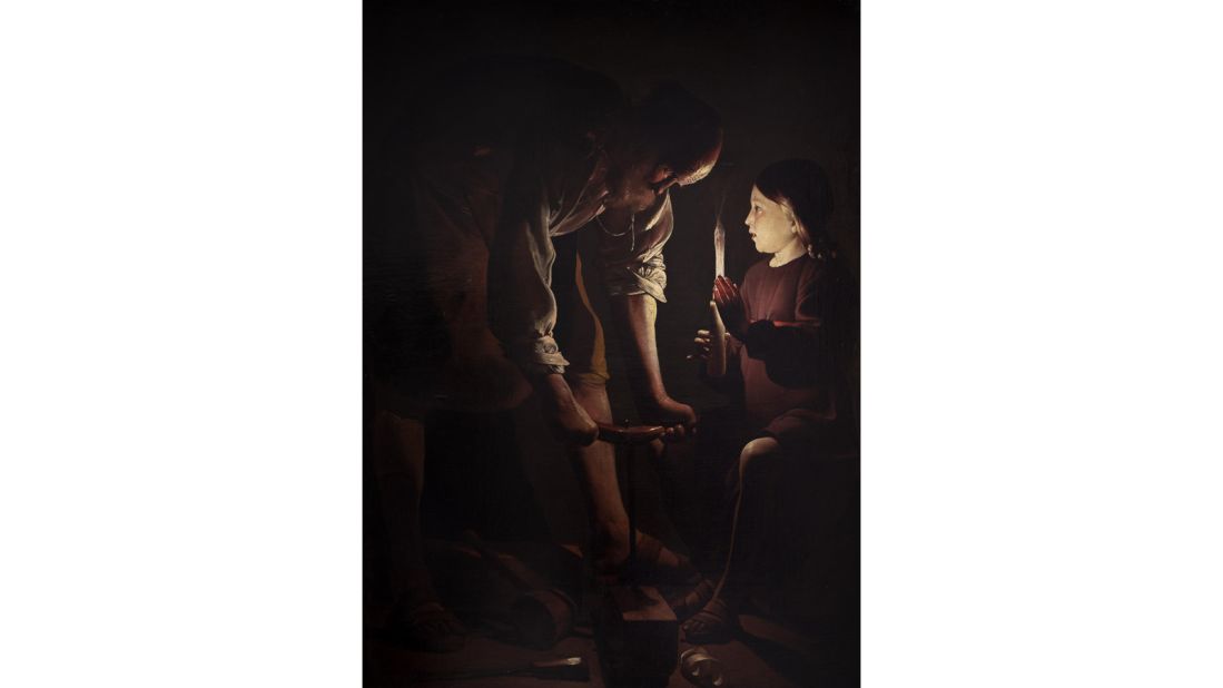 Here, eight-year-old Jesus Christ holds a candle for his stepfather, Joseph. The auger Joseph is using to drill a piece of wood creates the shape of the cross, referencing Jesus' future crucifixion.  