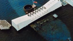 circa 1962:  An aerial view of the USS Arizona National Memorial, which spans the sunken hull of the battleship in Pearl Harbor, Oahu, Hawaii, and commemorates the site where the Japanese attacked on December 8, 1941 bringing America into World War II, and as a memorial to all the military personnel killed that day. (Photo by MPI/Getty Images)