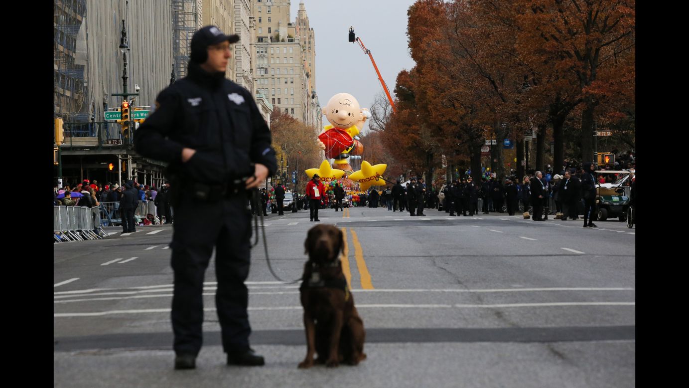 A New York police officer stands guard with his dog during the annual <a href="http://www.cnn.com/2016/11/24/us/gallery/macys-thanksgiving-parade-2016/index.html" target="_blank">Macy's Thanksgiving Day Parade</a> on Thursday, November 24.