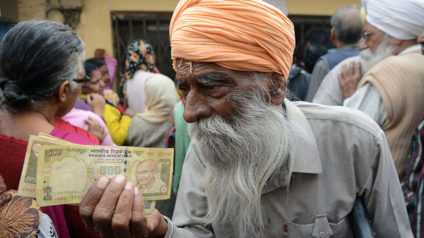 People gather outside a bank in Amritsar, India, as they wait to deposit 500- and 1,000-rupee notes on Saturday, November 19. The government, in an attempt to fight corruption and tax evasion, is withdrawing the country's two largest notes from circulation. But the currency exchanges <a href="http://money.cnn.com/2016/11/14/news/india/india-rupee-currency-anger/" target="_blank">have overwhelmed the country's banks</a> and inconvenienced citizens. 