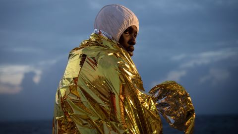 A man keeps warm after being rescued from the Mediterranean.