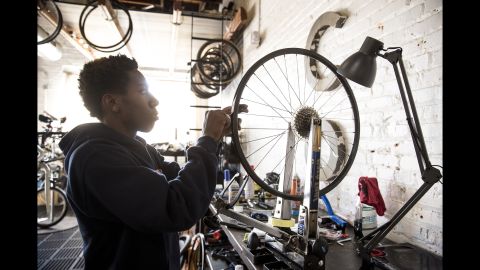 Richmond Cycling Corps' member Devonte, 17, picks out a bicycle and fits it with new tires at the Richmond Bicycle Studio.