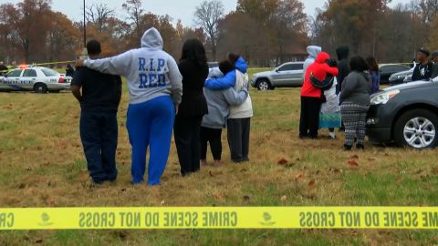 People comfort each other after a shooting at a park in Louisville Thursday.