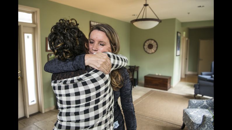 Stevens shares a hug with a resident of Magdalene.