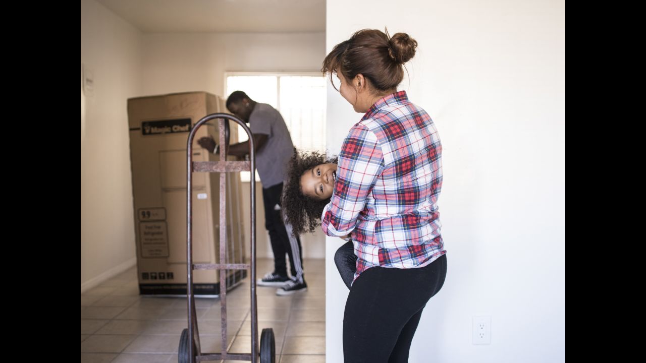 Smith's team unpacks and organizes housewares and furniture for Stephanie and her daughter Ja'el in their new apartment in Los Angeles.