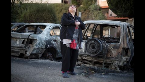 A woman surveys the massive damage in Haifa on Friday, November 25.