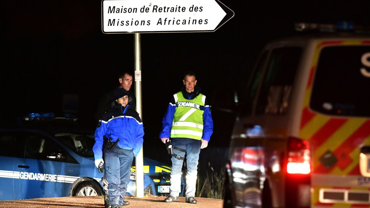 Gendarmes stand guard on a road near a retirement home for monks in Montferrier-sur-Lez, southern France, early on November 25, 2016, after an armed man burst in the home killing a woman with a knife.
Armed police were hunting the man inside the home, which is home to around 70 men and women who have served as missionaries in Africa. Authorities said it was a "criminal act". / AFP / PASCAL GUYOT        (Photo credit should read PASCAL GUYOT/AFP/Getty Images)