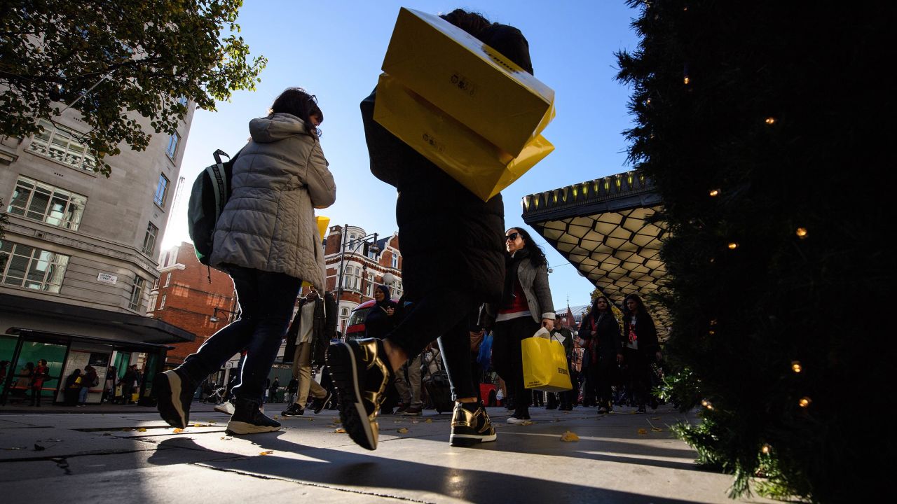 LONDON, ENGLAND - NOVEMBER 25:  Shoppers carry their purchases on Oxford Street as stores offer discounted items in their "Black Friday" sales on November 25, 2016 in London, England. Retailers have found that more shoppers are making their purchases online, avoiding the annual queues and rushes for early store opening times.  (Photo by Leon Neal/Getty Images)