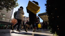 LONDON, ENGLAND - NOVEMBER 25:  Shoppers carry their purchases on Oxford Street as stores offer discounted items in their "Black Friday" sales on November 25, 2016 in London, England. Retailers have found that more shoppers are making their purchases online, avoiding the annual queues and rushes for early store opening times.  (Photo by Leon Neal/Getty Images)
