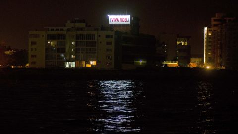 A sign that reads, "Long live Fidel," stands on a Cuban government building early Saturday in Havana.
