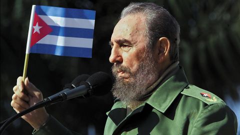 Cuban President Fidel Castro waves a flag during a visit on January 27, 2001 to the Havana neighborhood of San Jose de las Lajas.