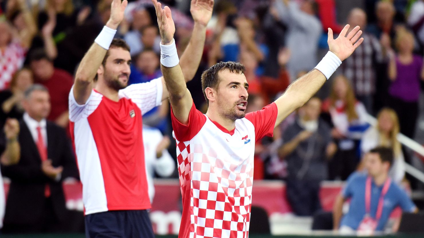 Croatia's tennis players Ivan Dodig (center) and Marin Cilic celebrate their doubles victory in the Davis Cup final.