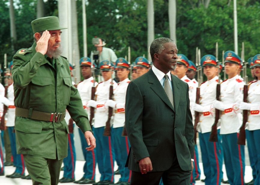 Castro and South African President Thabo Mbeki review the presidential guard at the Revolution Palace on March 27, 2001