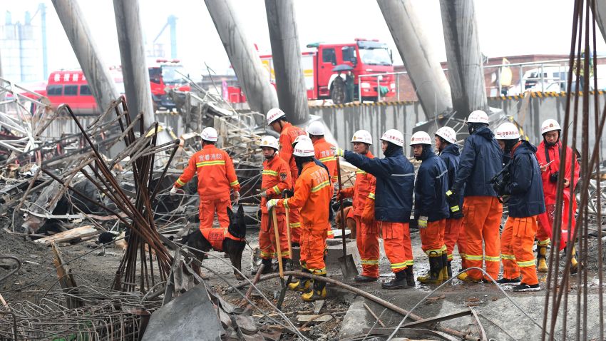 Rescue workers prepare to search through the remains of a collapsed platform in a cooling tower at a power station at Fengcheng, in China's Jiangxi province a day after the collapse, on November 25, 2016. 
Chinese authorities have detained 13 people in connection with a construction collapse at the power station which killed at least 74 people, state media said on November 25, the latest industrial accident in the country. / AFP / -        (Photo credit should read -/AFP/Getty Images)