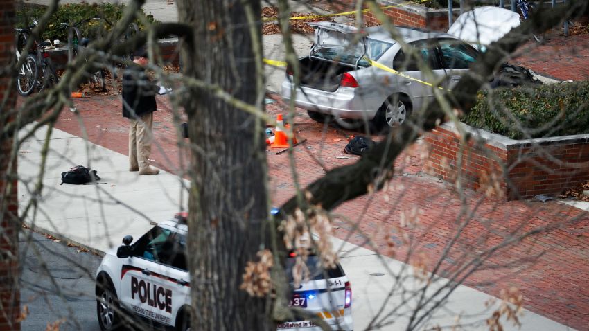 A car inside a police line sits on the sidewalk as authorities respond to an attack on campus at Ohio State University, Monday, Nov. 28, 2016, in Columbus, Ohio. (AP Photo/John Minchillo)