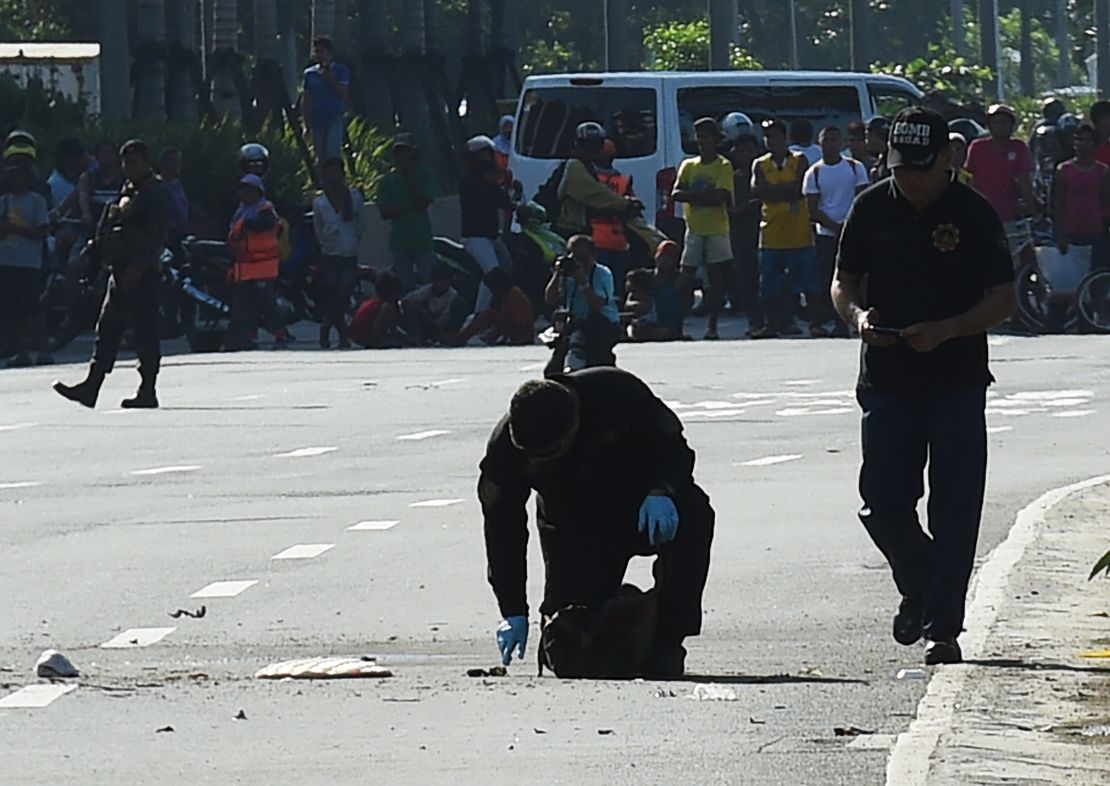 Bomb disposal officers inspect an improvised explosive device in Manila on November 28. 