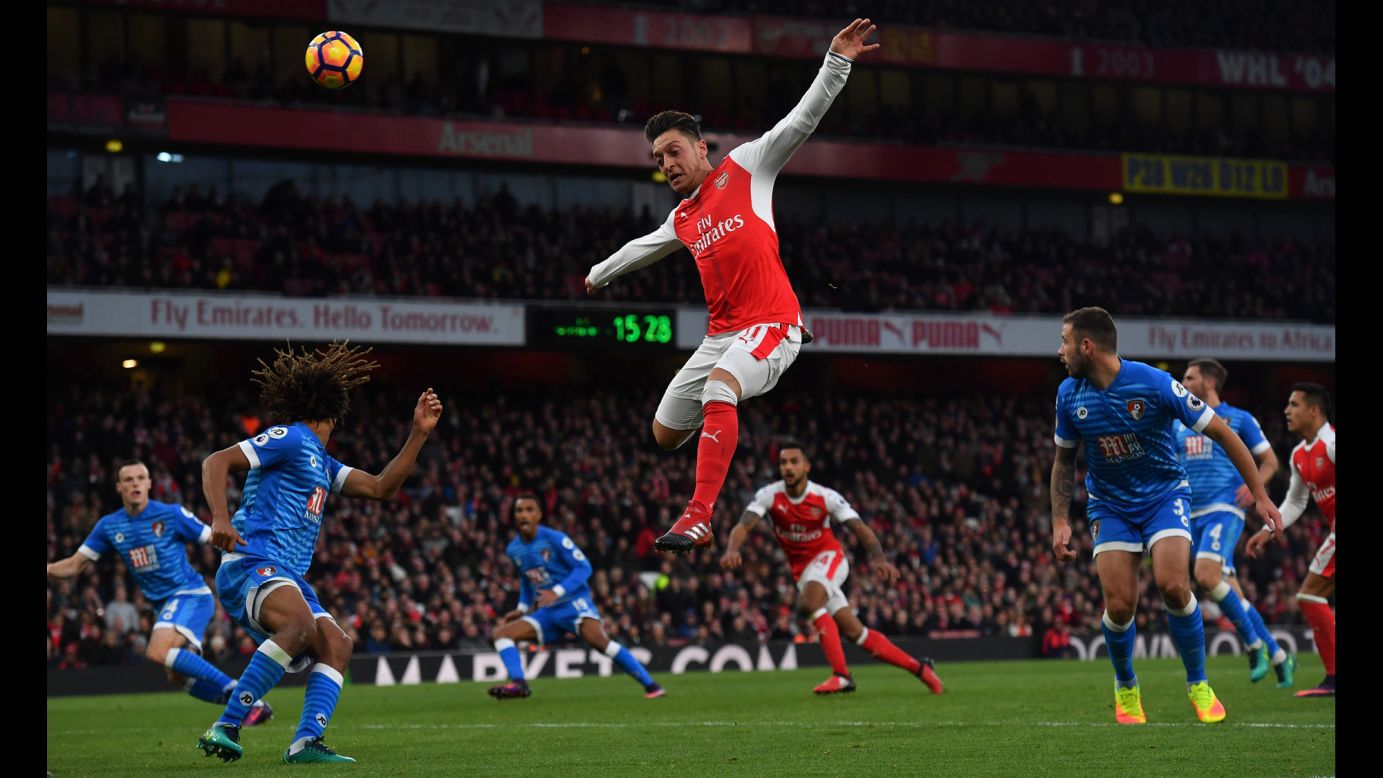 Arsenal midfielder Mesut Ozil leaps for the ball Sunday, November 27, during a Premier League match in London against Bournemouth.