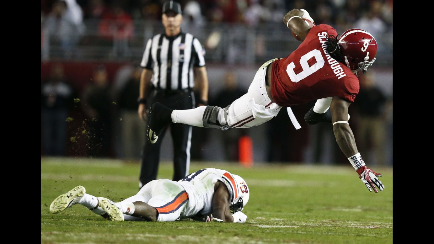 Alabama running back Bo Scarbrough jumps over an Auburn player during a college football game in Tuscaloosa, Alabama, on Saturday, November 26. Alabama won the rivalry game 30-12 to finish the regular season undefeated.