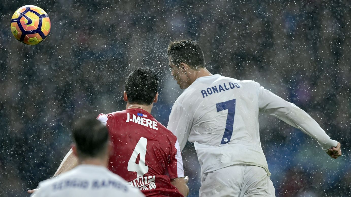 Real Madrid star Cristiano Ronaldo heads the ball during a Spanish league match against Sporting Gijon on Saturday, November 26. Madrid won 2-1, with Ronaldo scoring both goals.