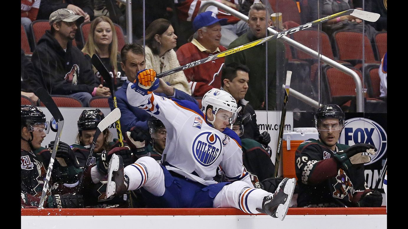 Edmonton captain Connor McDavid leaps into the opposing team's bench during an NHL hockey game in Glendale, Arizona, on Friday, November 25.